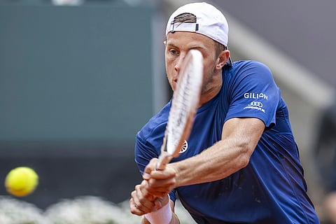 Tallon Griekspoor returns a ball to Novak Djokovic